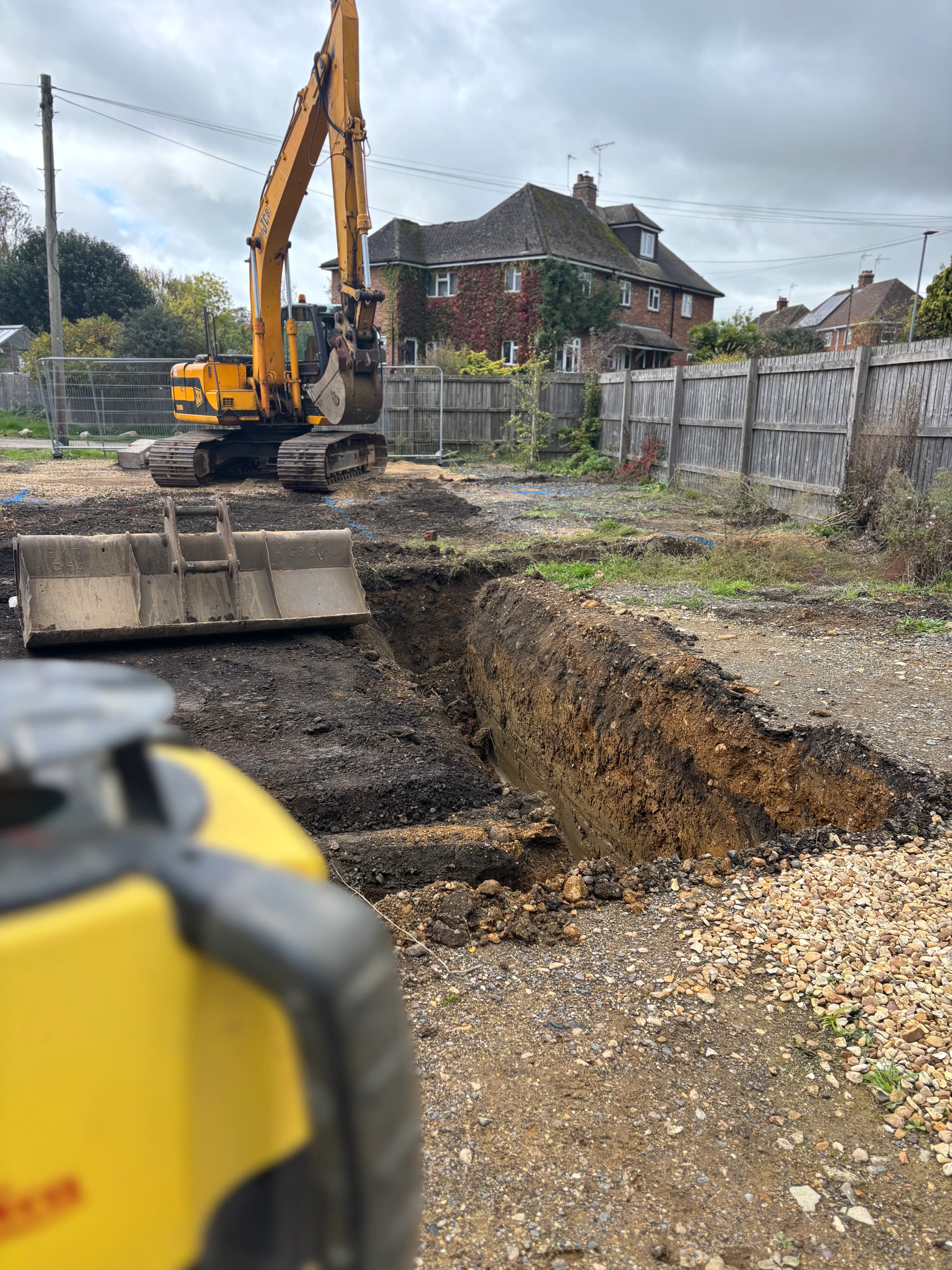 A construction site with a bulldozer in the background.