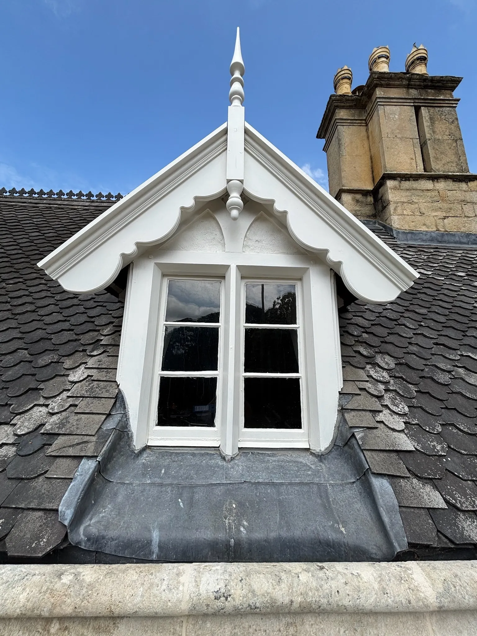 A white window on top of a roof.
