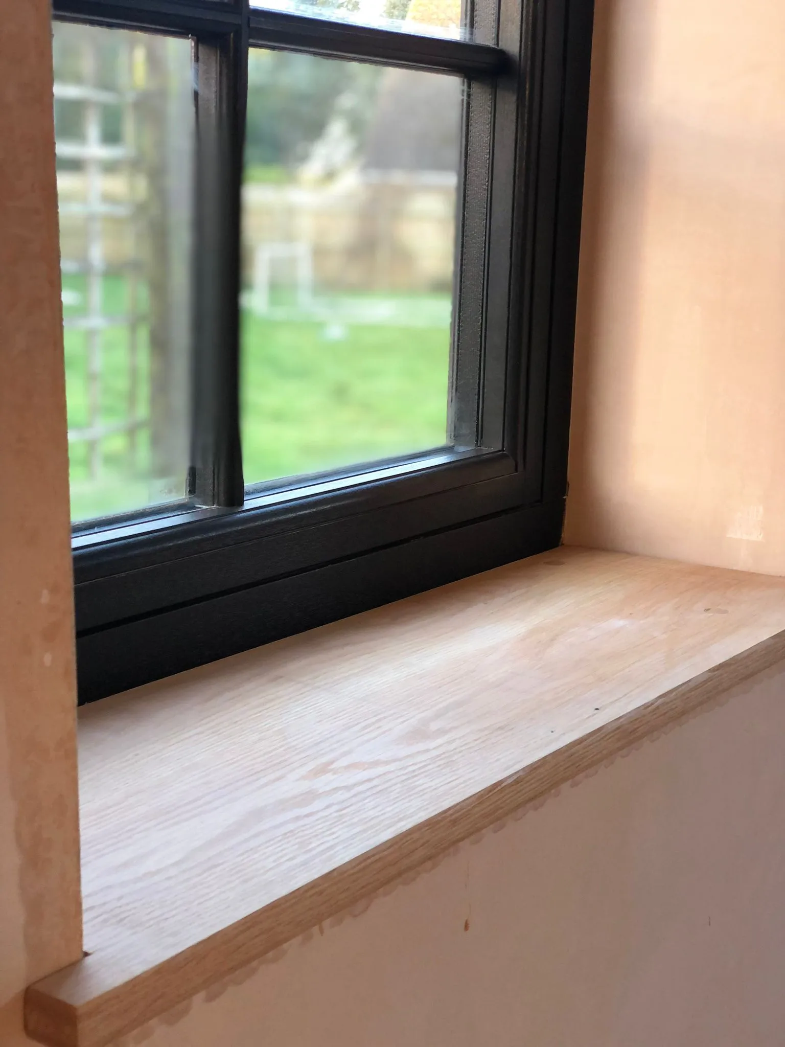 a window sill with a window pane in the background