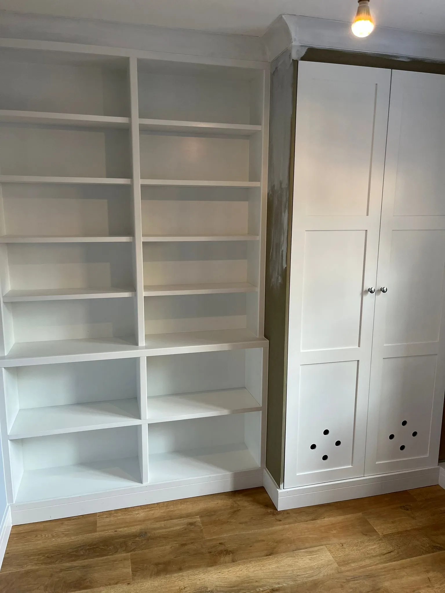 a large white bookcase in a room